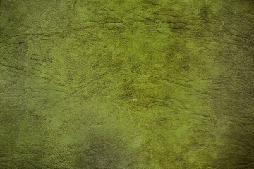 Green textured background creating rough uneven surface with light and shadow
