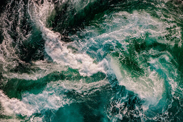 Blue waves of water of the river and the sea meet each other during high tide and low tide.