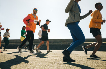 Male runner making finger guns during a community race event