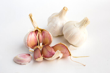 Garlic heads and cloves on white background