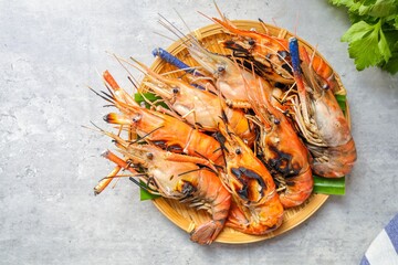 Grilled prawn, grilled shrimp in the basket plate on cement background