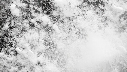 Abstract close-up of white water with black background creating a dynamic texture.