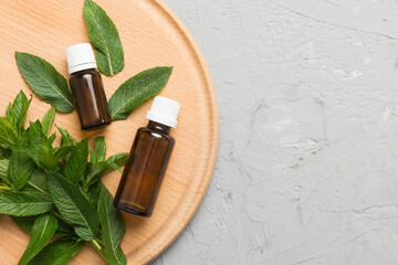 Natural Mint Essential Oil in a Glass Bottle. organic cosmetics with herbal extracts of mint on...
