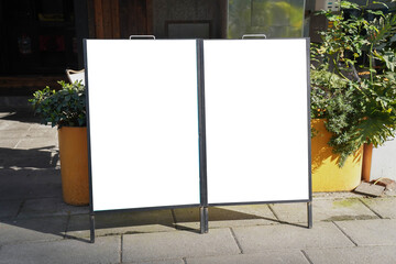 Two blank white outdoor advertising stand sandwich boards mock up template. Clear street signage...