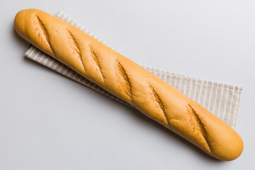 fresh crunchy french baguette on colored table. Top view Bakery products