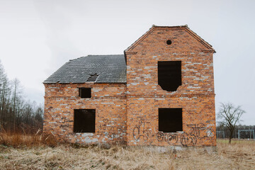 Isolated abandoned red brick house in the middle of nowhere – haunted mood, silence, and echoes...