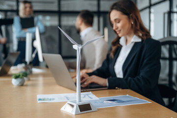 Side view, by the table. Business people are working in the office