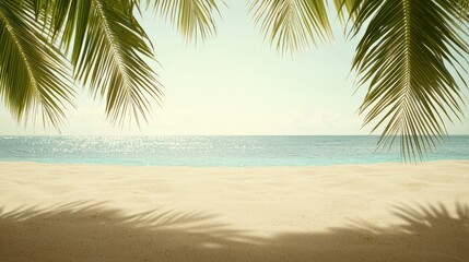 Obraz premium A serene beach scene with soft sand and gentle waves. Palm leaves frame the view, offering a sense of relaxation and peace. Ideal for evoking a tropical vacation atmosphere.