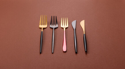Knife and fork, cutlery on a brown dining table