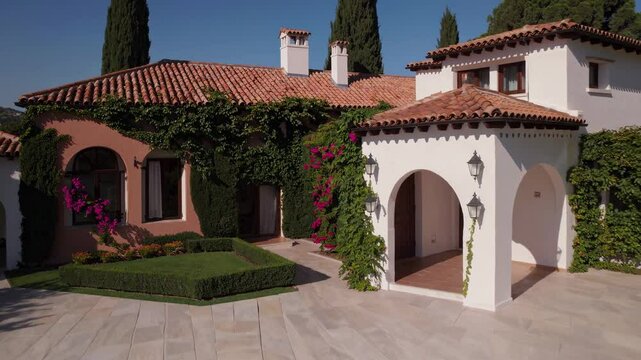 Beautiful sunny outdoor exterior of luxurious Mediterranean mansion with serene blue swimming pool, classic garden, green cypress trees idealizing wealthy relaxation vacation