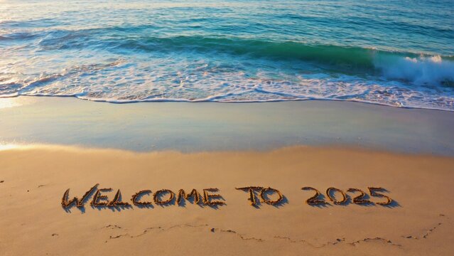 A sunset greeting on the sand welcoming visitors to the beach for a vacation in 2015.