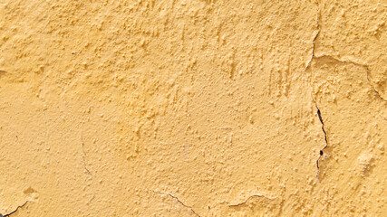Yellow wall with surface imperfections