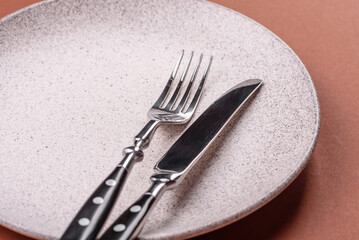 Empty ceramic plate on a monochrome brown background