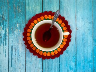 Cup of tea and crocheted doily mandala photo	
