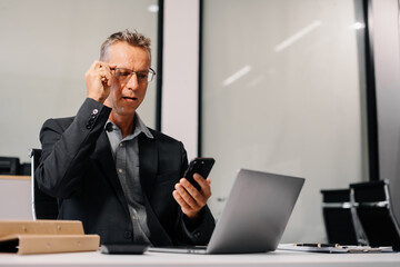 Businessman talking on the phone giving professional consultation to client or negotiating project. problems highlighting customer dissatisfaction.