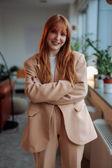 Redhead businesswoman posing at work