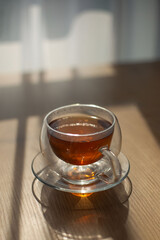 tea cup on the table against the sunlight