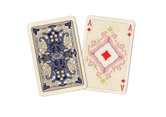 A pair of antique playing cards with one card revealed in the suit of diamonds.