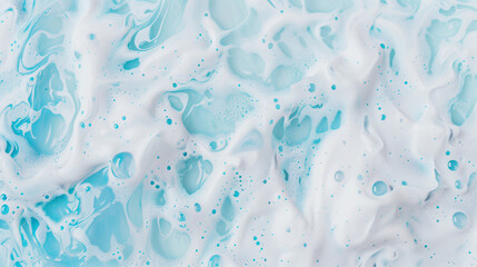 Naklejka premium The image is of a blue ocean with white foam. The foam is scattered throughout the ocean, creating a sense of movement and energy. The blue color of the ocean