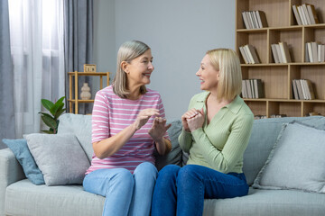 Two women sitting on the sofa and having a nice talk