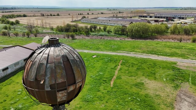 Drone picture of an old soviet water tank watching over an abandoned soviet farm in Romania, on the island of Borcea. Some parts of the farm have been rehabilitated to this day.