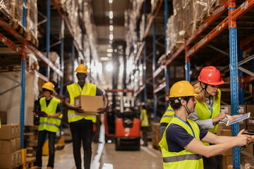 Warehouse workers managing inventory and logistics with digital tablet