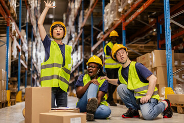 Warehouse workers reacting to workplace accident, injured colleague and calling for help