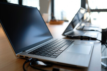 Row of laptops being prepared and set up for new employees in a company