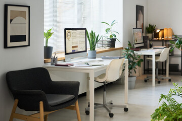 Workplaces of employees with computers in modern office