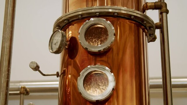 Close-Up of Copper Distillation Apparatus with Pressure Gauge and Viewing Ports