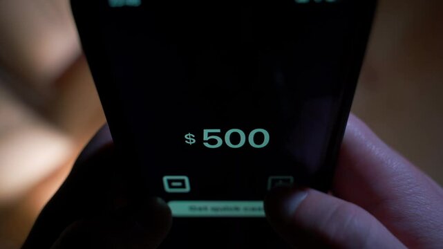 Borrowing money via phone, close-up. Fictional app for getting quick loans. Man borrows 550 dollars