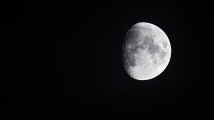 Naklejka premium Waxing gibbous moon in night sky.