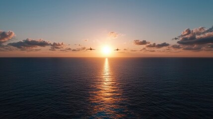 Naklejka premium Aircraft flying over the ocean at sunset with orange sky & water reflection