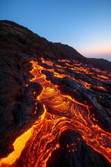 Fototapeta premium Flowing Lava Cascade Molten Stream on Volcanic Slope during Nighttime
