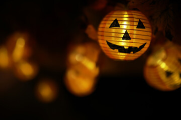 Glowing Halloween Pumpkin Lanterns on a Dark Background with Bokeh Effect