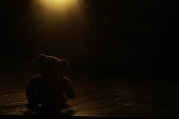 Lonely Teddy Bear in Dim Light - Symbol of Isolation, Nostalgia, and Childhood Memories