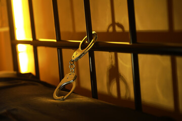 Handcuffs Attached to Metal Bed Frame - Concept of Restriction and Confinement