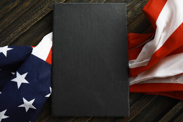 Blank Black Slate Surrounded by American Flag on Wooden Background for Patriotic Concept