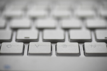 Close-Up of White Keyboard with Focus on CVBN Keys in Modern Office Setting