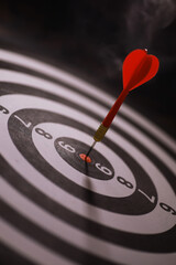 Fototapeta premium Red Dart Hitting Bullseye on Black and White Target - Precision, Goal, Success