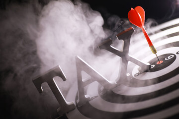 Targeted Tax Concept - Bullseye with Red Dart on Tax Letters, Symbolizing Precision in Taxation