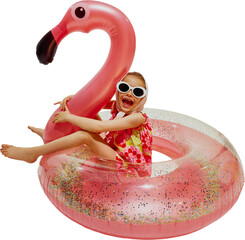 Funny little girl, sitting in inflatable flamingo float and having fun as she swimming in pool...