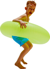 Excited little boy in swimming shorts leaping with inflatable circle, as he jumps to water against transparent background. Concept of hot summer holidays, vacation, camps, recreation.