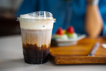 Glass of iced coffee in coffee shop, copy space and isolate concept.