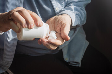 an elderly woman drinks medicine