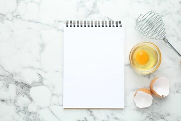 Blank recipe book, whisk and eggs on white marble table, top view. Mockup for design