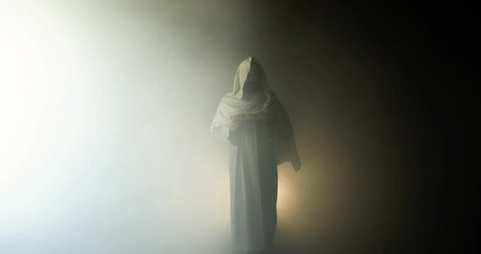 Jesus Christ holding bread, symbolizing salvation, gospel, resurrection in contrasting light and darkness. Perfect for Easter resurrection visual or worship background.