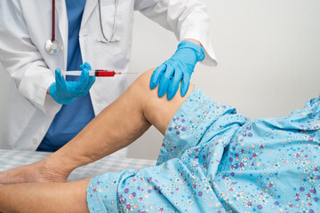 Asian doctor inject Hyaluronic acid platelet rich plasma into knee of senior woman.