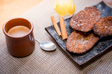 Traditional Spanish torrijas, dessert often enjoyed during Lent and Holy Week or Semana Santa, and Easter, similar to french toast, with cup or coffee or cappuccino, ready for breakfast