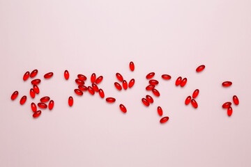 Red pills and capsules scattered. Concept of medicine, healthcare, and pharmaceutical industry